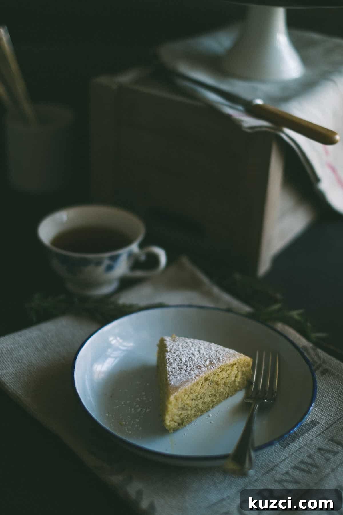 a slice of lemon rosemary olive oil cake  served on a plate 