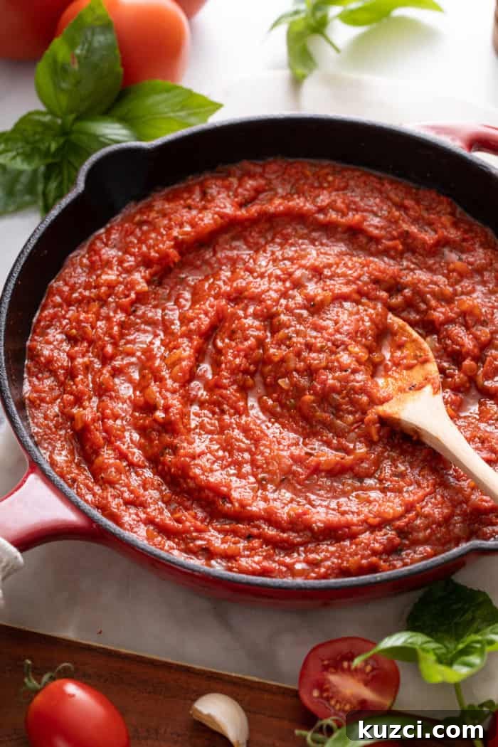 15-Minute Homemade Marinara Sauce for Pasta 3 Close up of quick marinara sauce being stirred in a skillet.