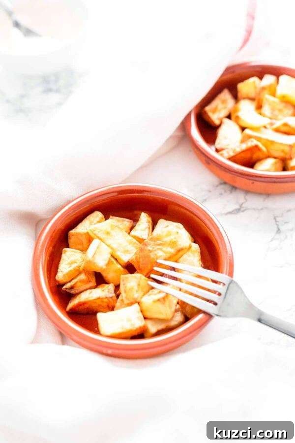 Crispy Air Fryer Patatas Bravas with Spicy Tomato Sauce 5 Air Fryer patatas bravas served in a stone bowl with aioli or brava sauce.