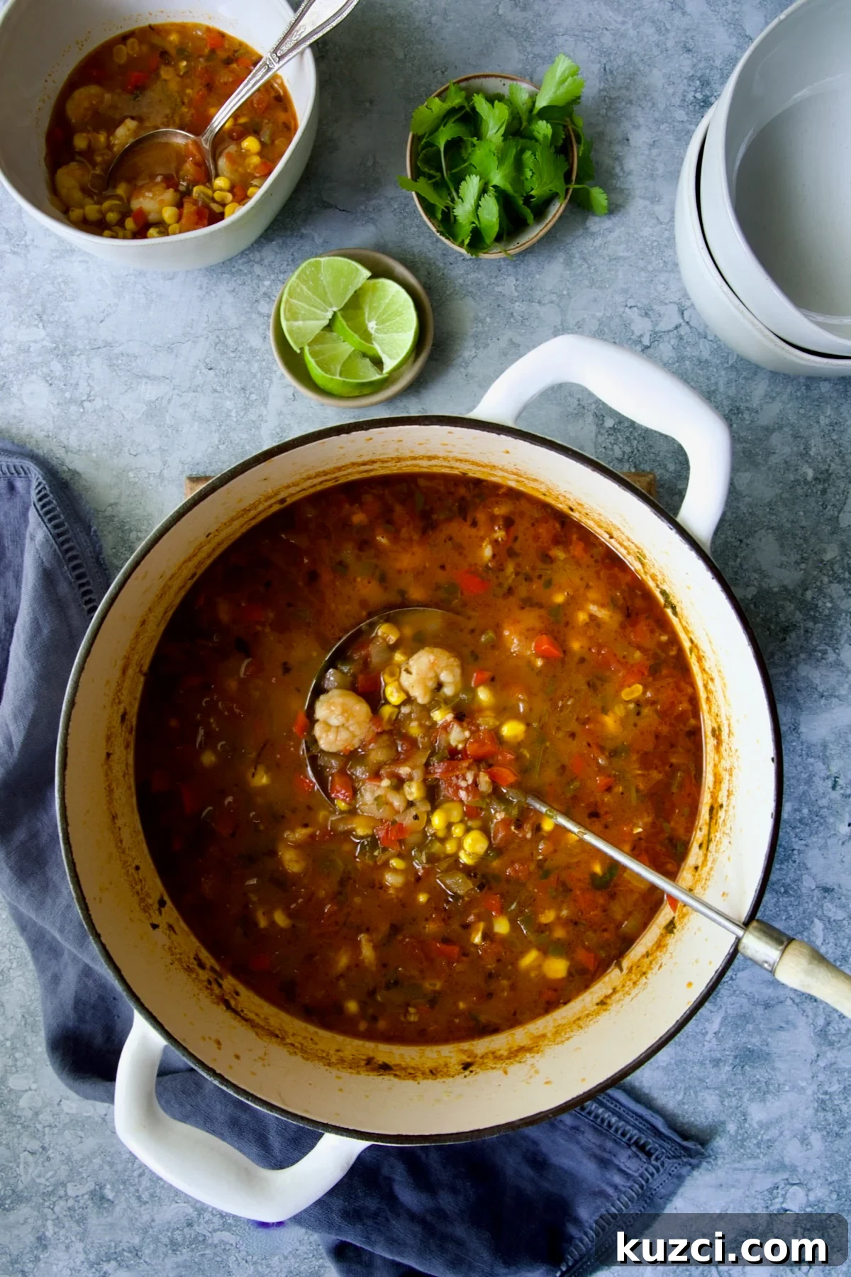 Creamy Shrimp and Corn Soup Recipe 11 Shrimp and Corn Soup in Dutch oven with soup ladle taking some out.