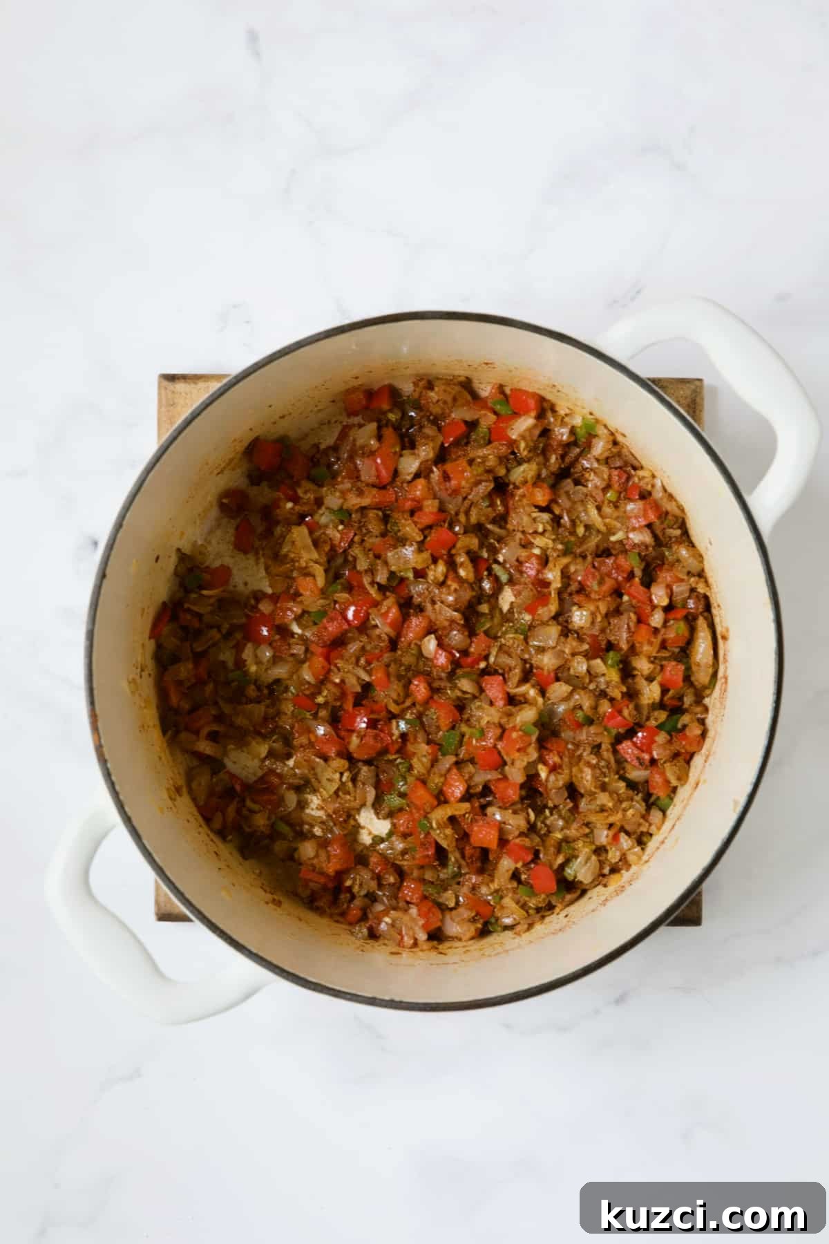 Creamy Shrimp and Corn Soup Recipe 8 Vegetables with spice blend in white Dutch oven.