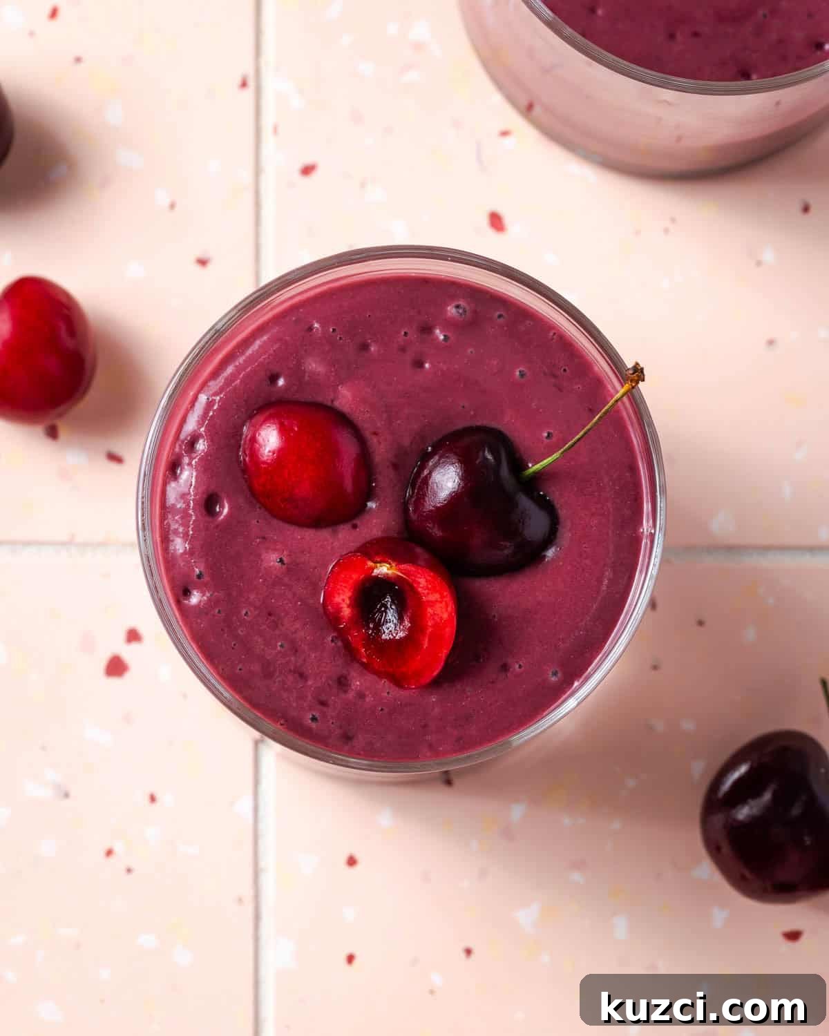 Creamy Cherry Smoothie Recipe 2 A cherry smoothie topped with a few fresh cherries.