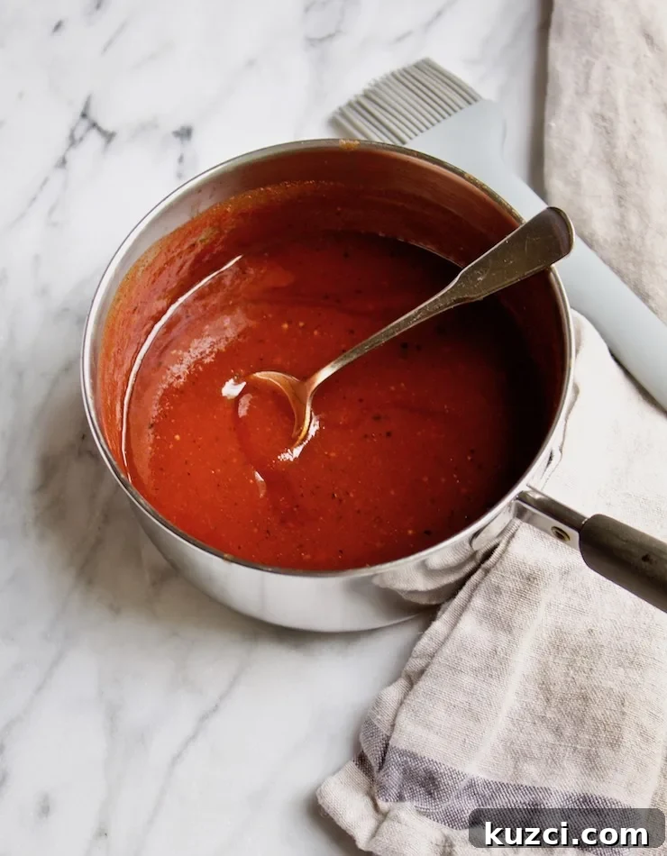 Homemade BBQ sauce in pan with brush.