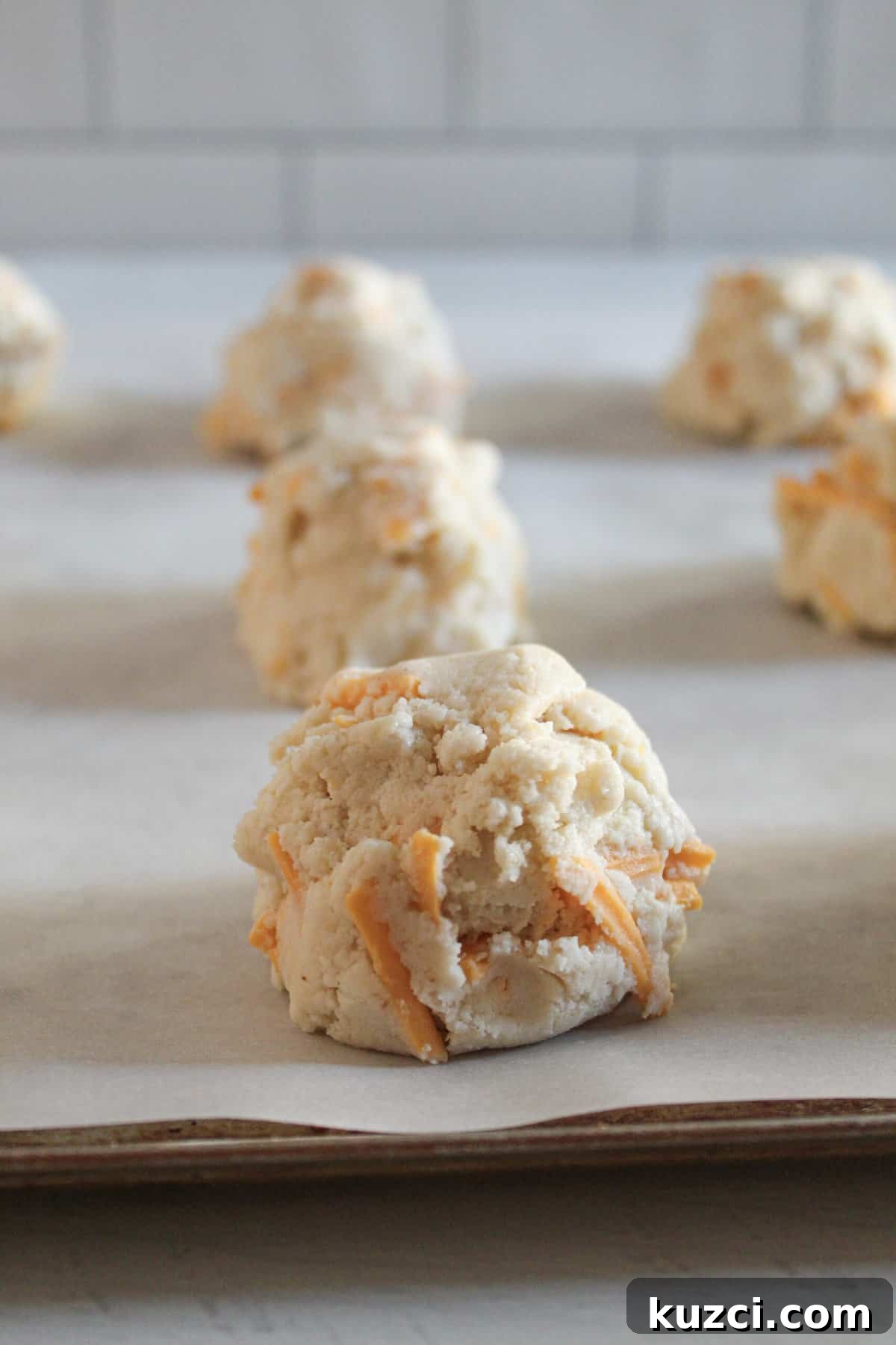 Gluten Free Dairy Free Cheddar Bay Biscuits Copycat 10 scooped gluten free cheddar biscuit dough on a baking tray.