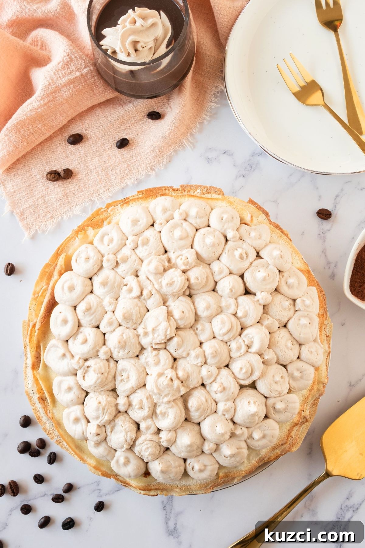 Classic French Crepe Cake (Mille Crepes) Recipe 7 Crepe cake topped with frosting before dusting with chocolate powder.