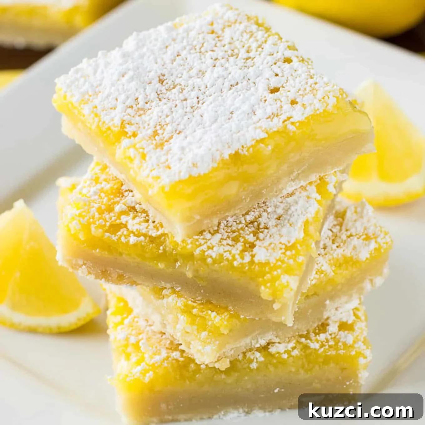 Zesty Lemon Bars Recipe with Buttery Shortbread Crust 2 Lemon bars in a stack.
