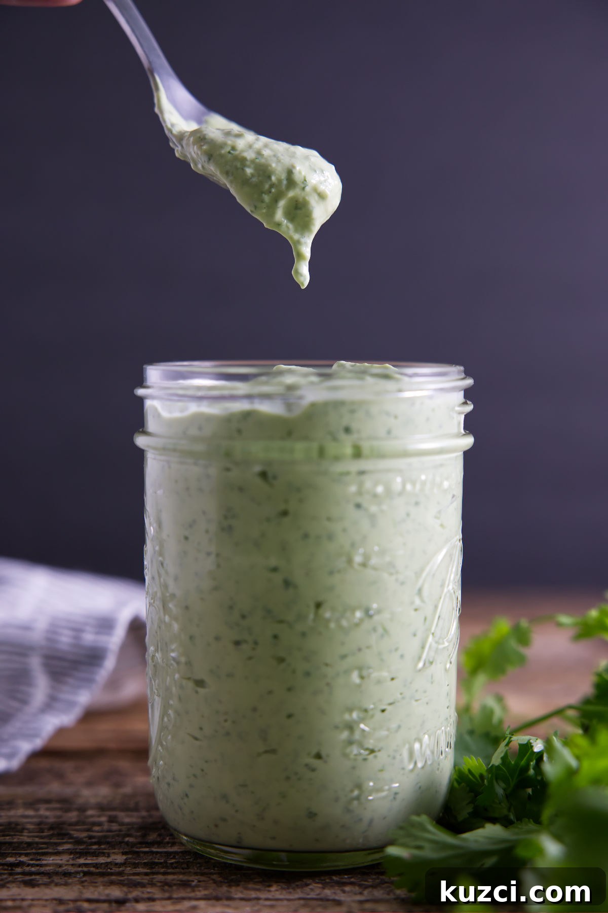 Avocado Lime Crema Recipe 15 Spoon full of avocado crema sauce straight from the jar.