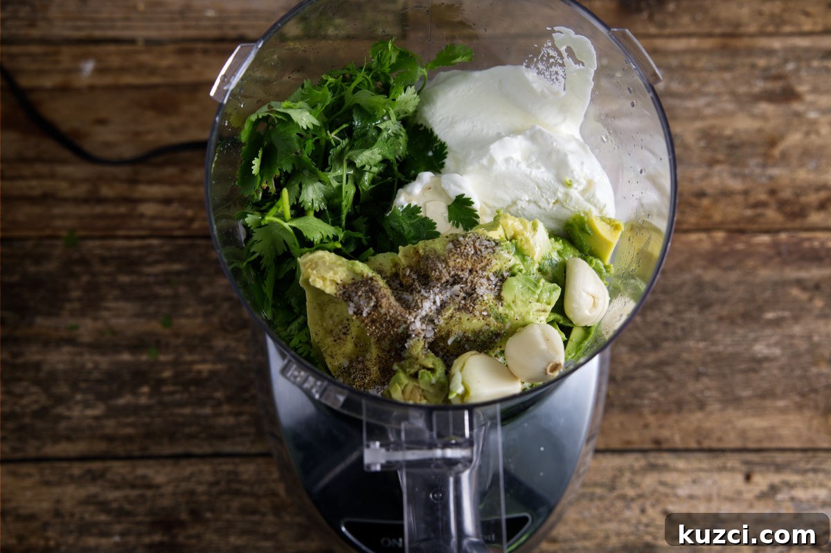 Avocado Lime Crema Recipe 5 Ingredients for avocado crema in a food processor.