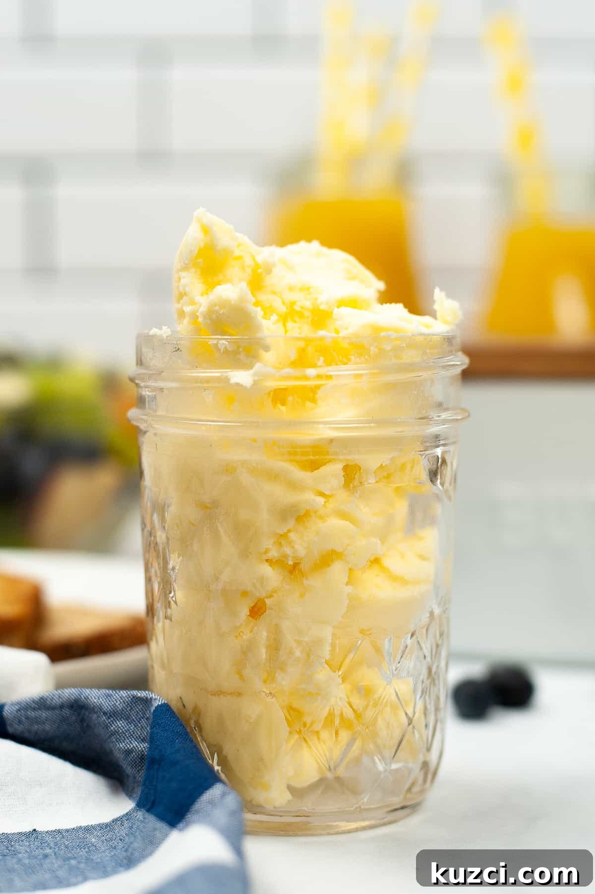 Mason jar filled with homemade butter on a kitchen countertop