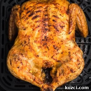 Crispy Whole Chicken in the Air Fryer 9 Whole chicken in air fryer basket, fully cooked and ready to remove, slice, and serve.