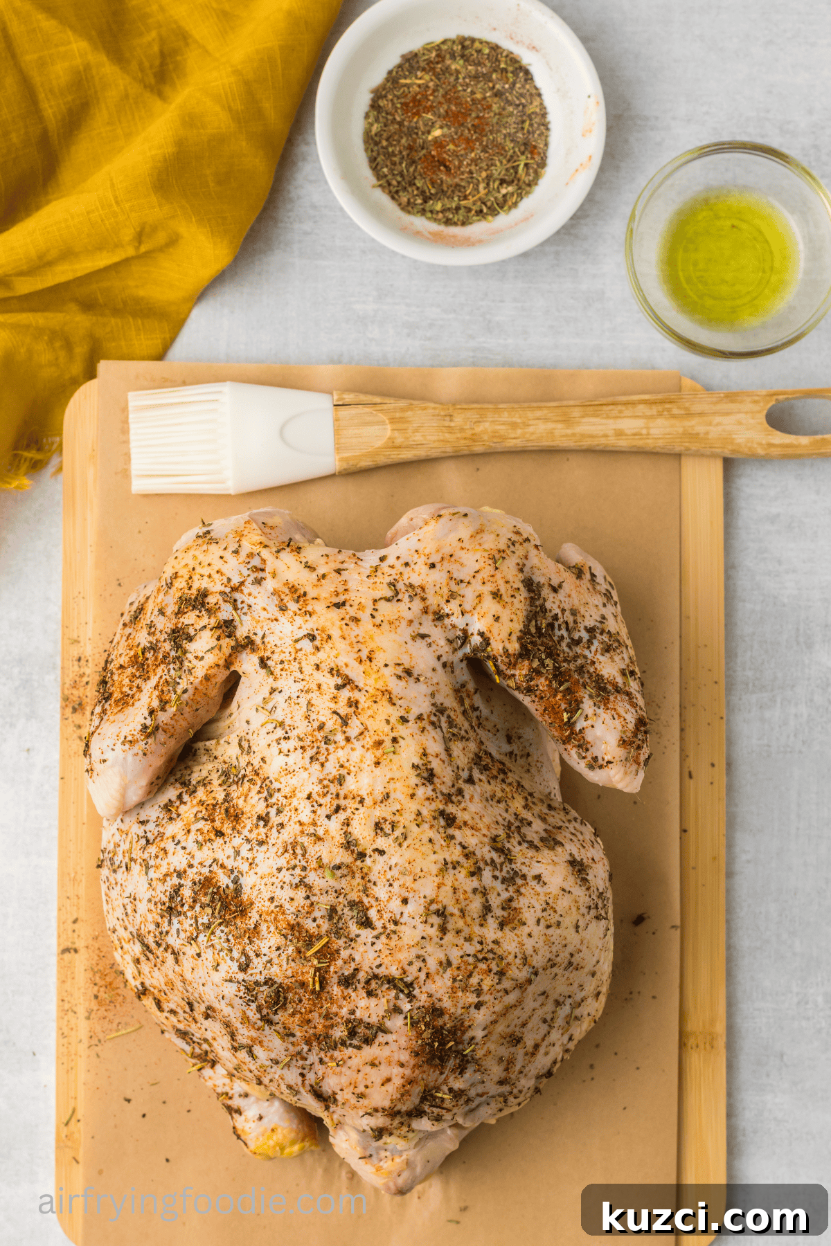Crispy Whole Chicken in the Air Fryer 5 whole chicken brushed with olive oil and rubbed with seasonings.