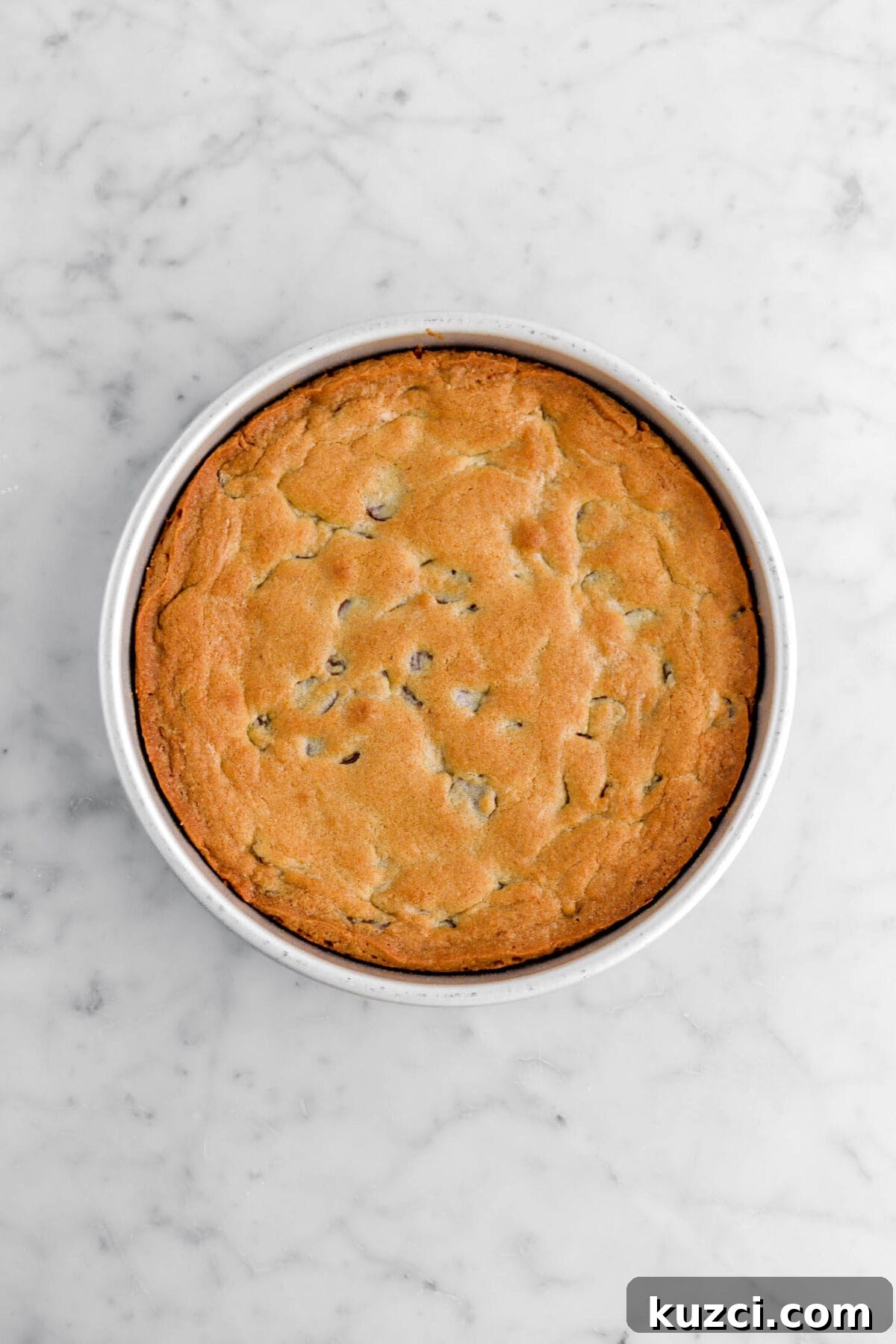 Chocolate Chip Cookie Cake with Chocolate Buttercream 20 baked chocolate chip cookie in large cake pan.