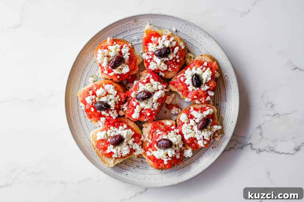 Cretan Dakos: Authentic Barley Rusk Salad Recipe 2 Simple Cretan tomato and feta rusks served as a Greek appetiser