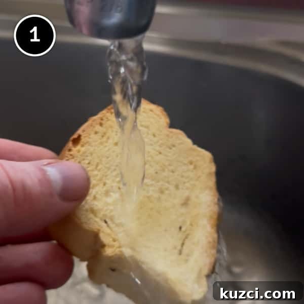 Cretan Dakos Salad | cookeatworld.com Running paximadia rusks under cold water to soften slightly