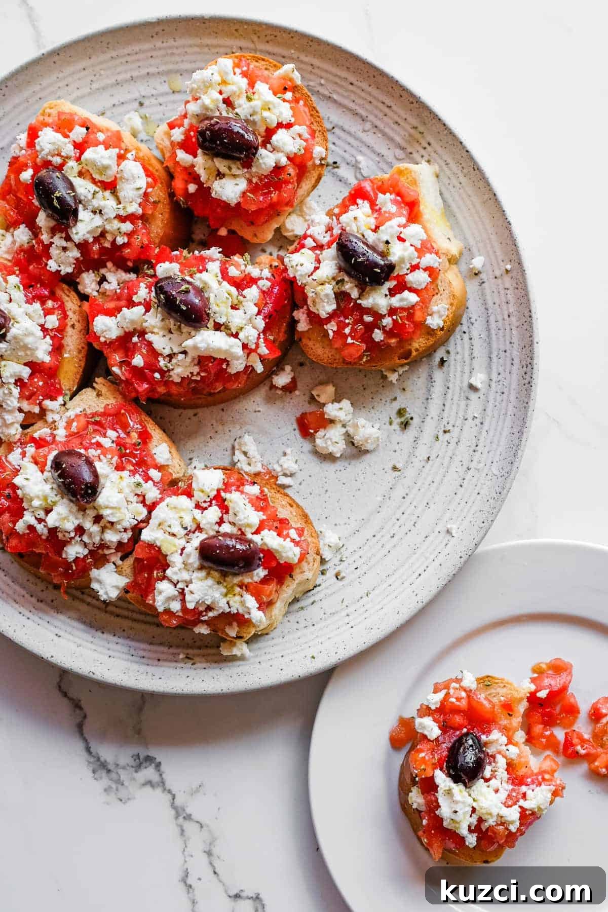 Cretan Dakos Salad | cookeatworld.com Authentic Cretan dakos served on a rustic platter with olives and oregano