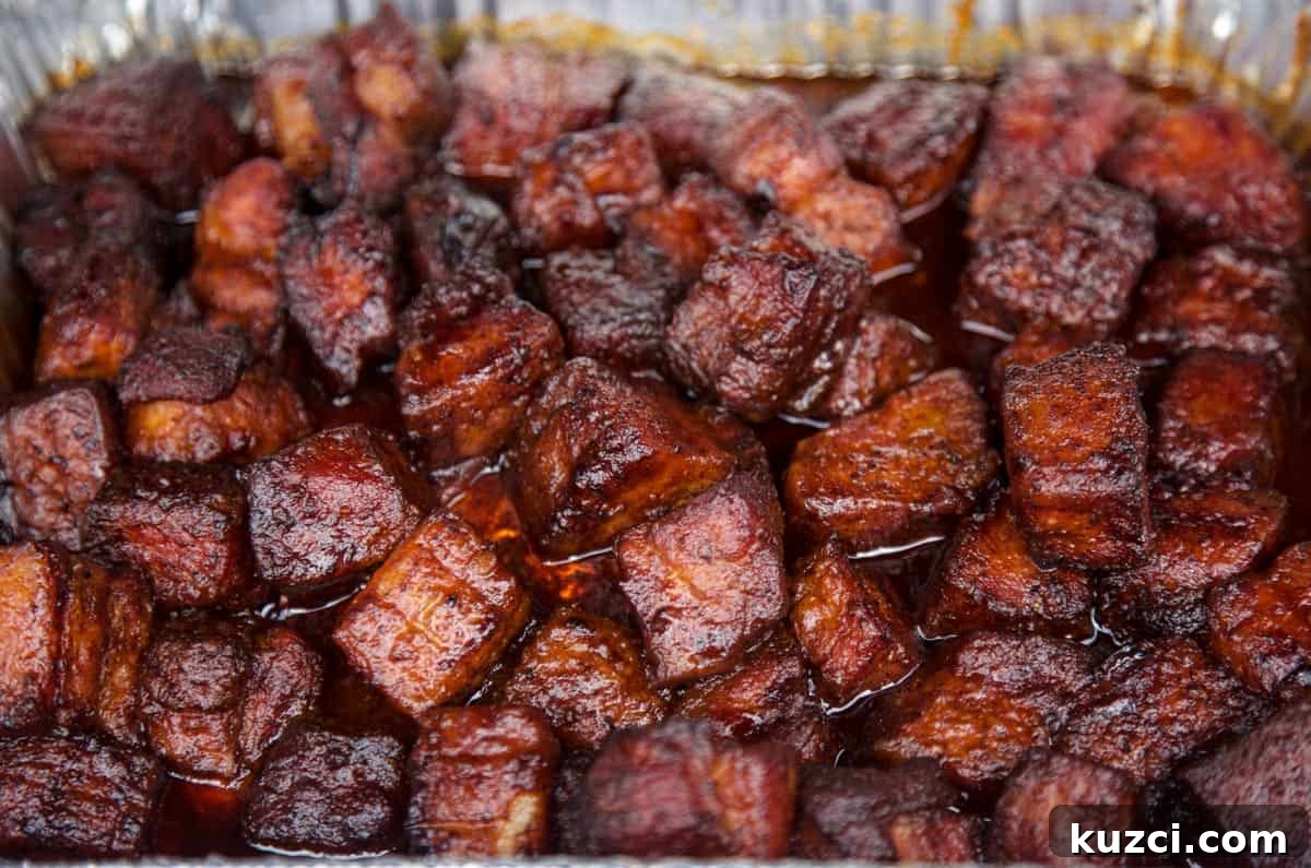 Smoked Pork Belly Burnt Ends: How to Make Sticky, Crispy Bites 3 Pork Belly Burnt Ends in a large sheetpan