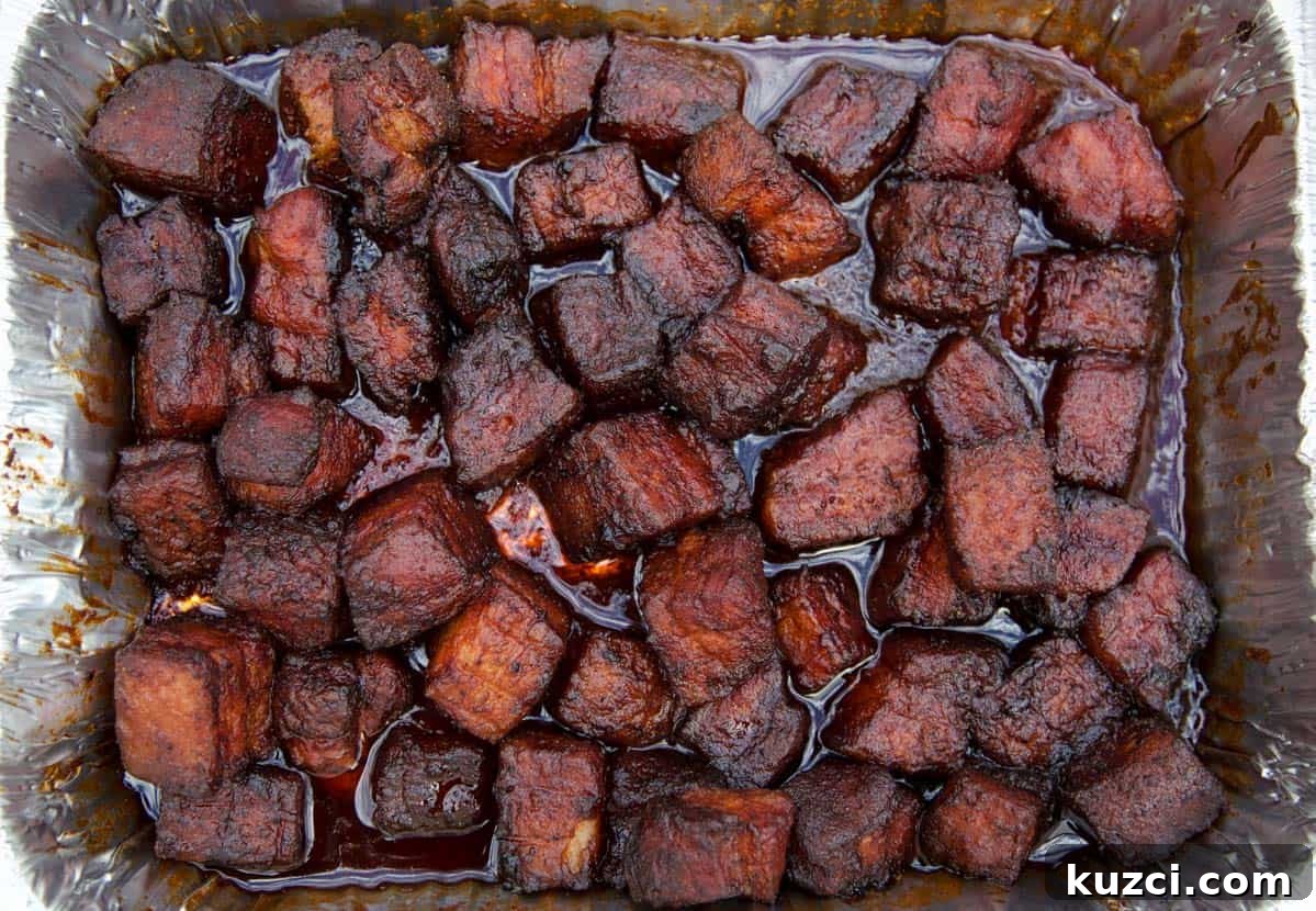Smoked Pork Belly Burnt Ends: How to Make Sticky, Crispy Bites 7 Smoked Pork Belly Burnt ends fully cooked in an aluminum pan