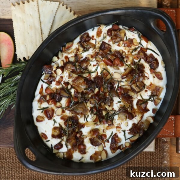 Creamy Baked Onion Dip Recipe with Caramelized Onions 11 whipped goat cheese dip in a serving dish topped with dates, rosemary, and shallots