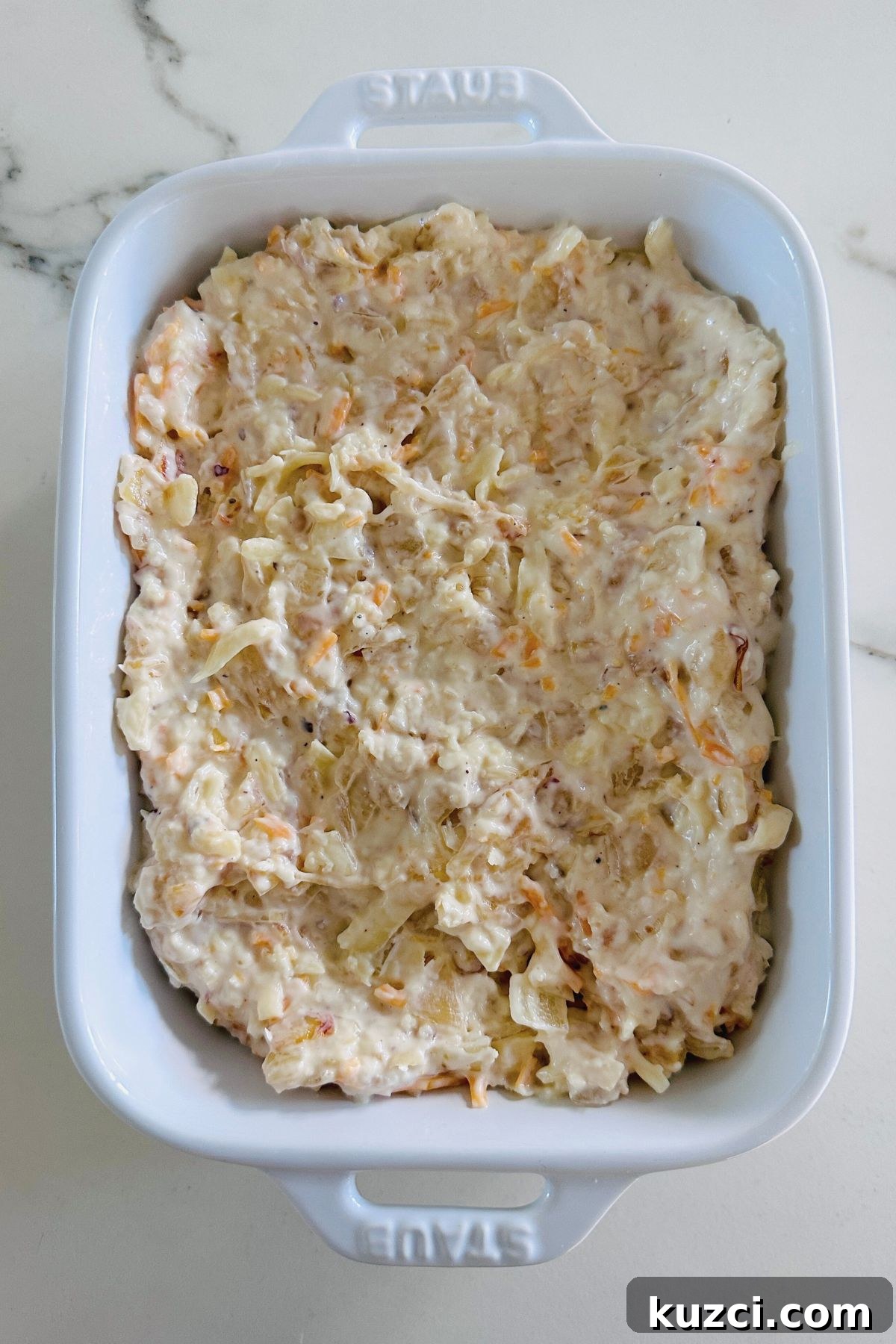 Creamy Baked Onion Dip Recipe with Caramelized Onions 5 Onion dip in a large white oven-safe baking dish; ready to bake.