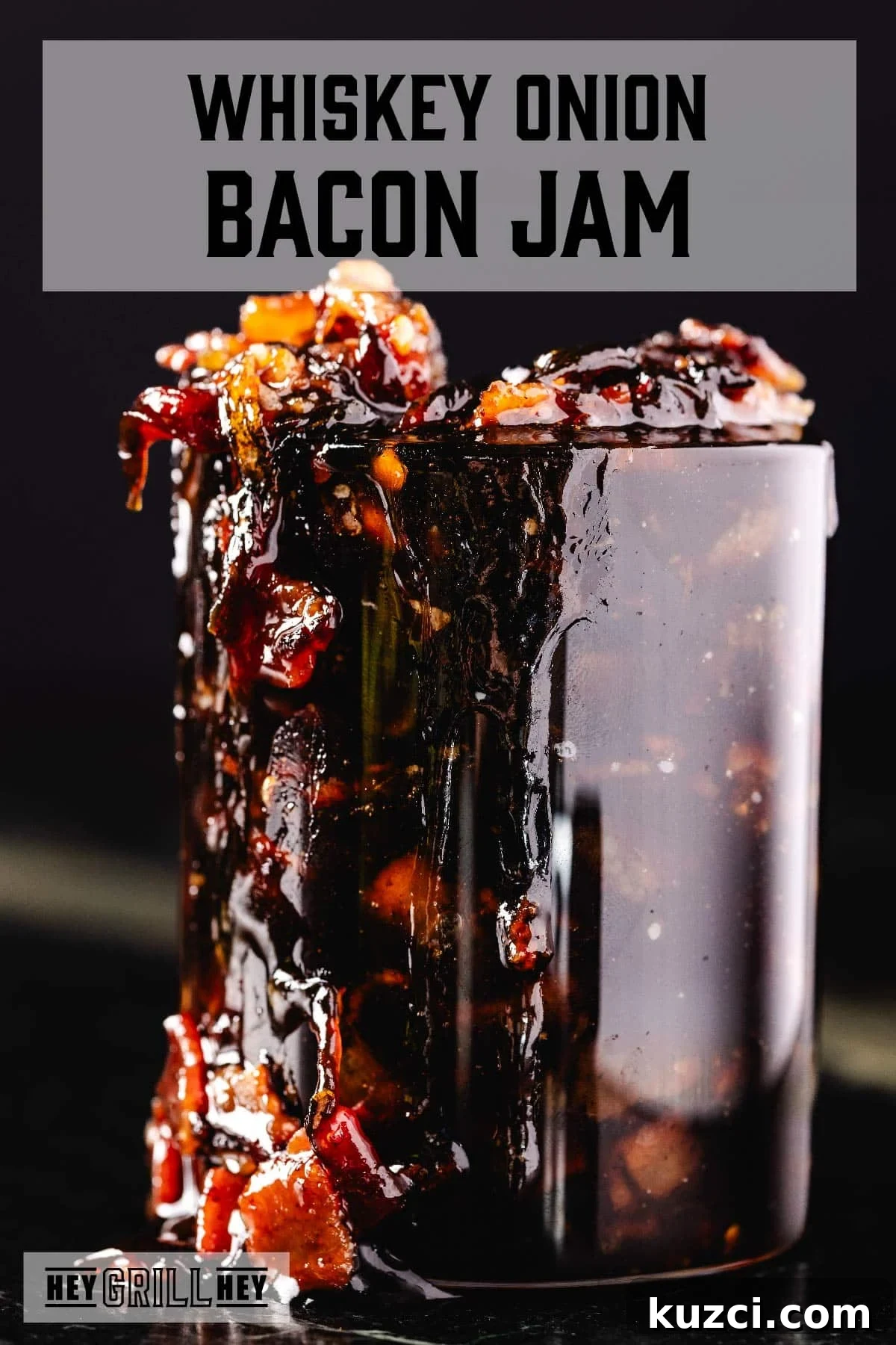 A mason jar overflowing with bacon jam. The text overlay reads "Whiskey Onion Bacon Jam" at the top, and "Hey Grill Hey" at the bottom.