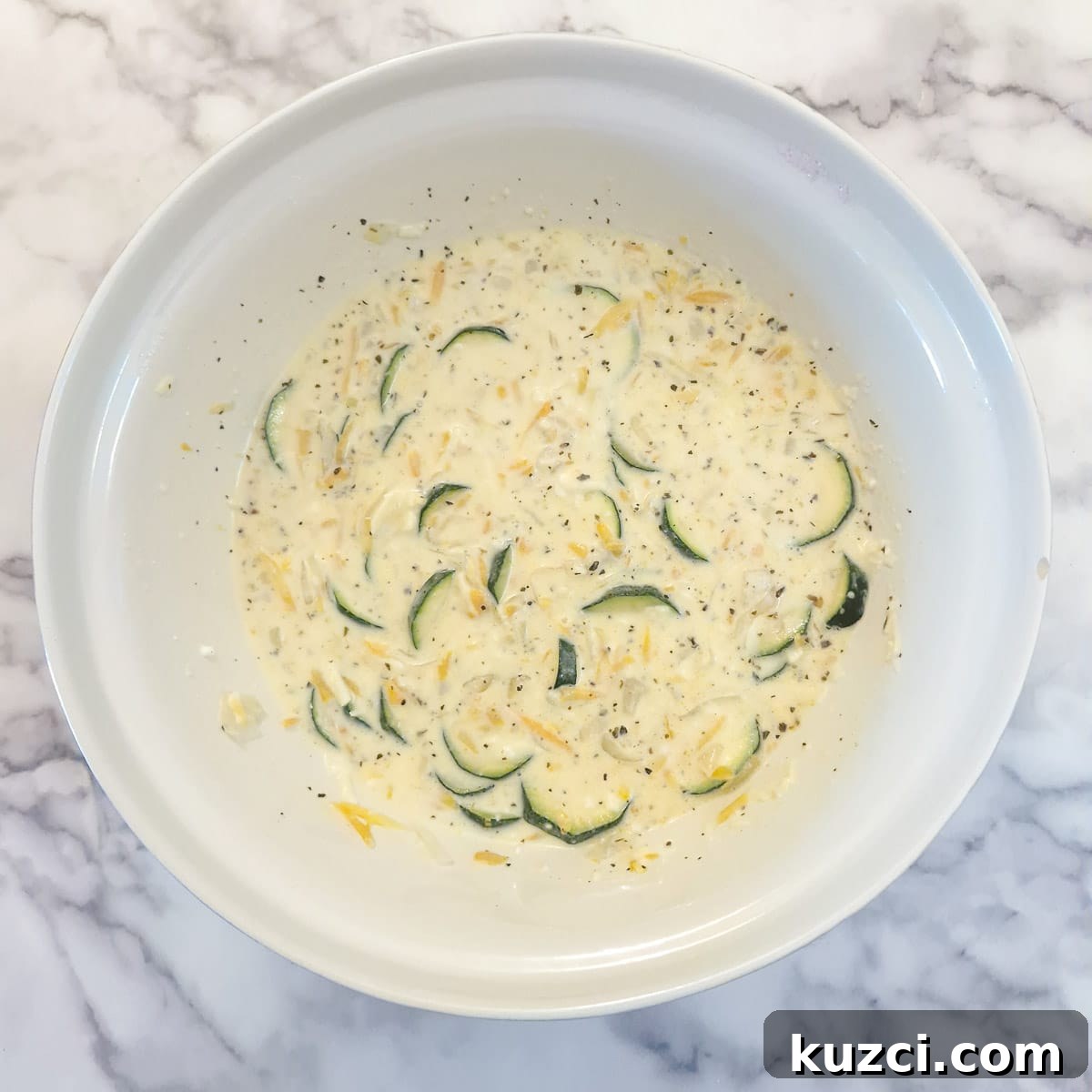 Crustless Cheesy Zucchini and Carrot Quiche 9 The softened vegetables and grated cheese added to the quiche batter.