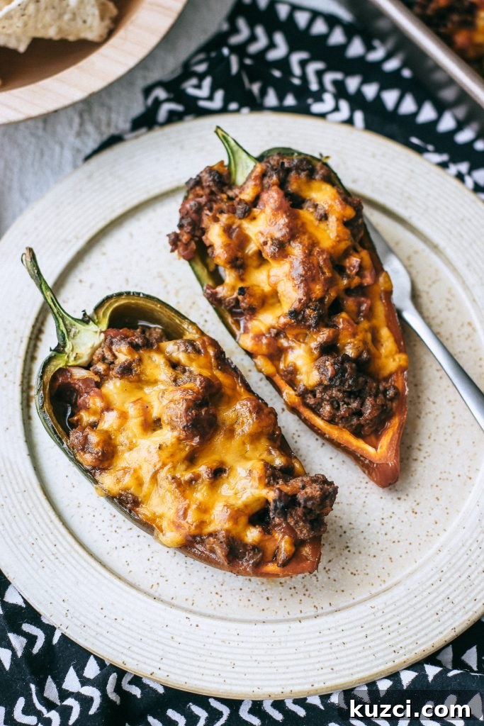 Spicy Low-Carb Stuffed Poblano Peppers Recipe 3 cheesy stuffed peppers on a plate
