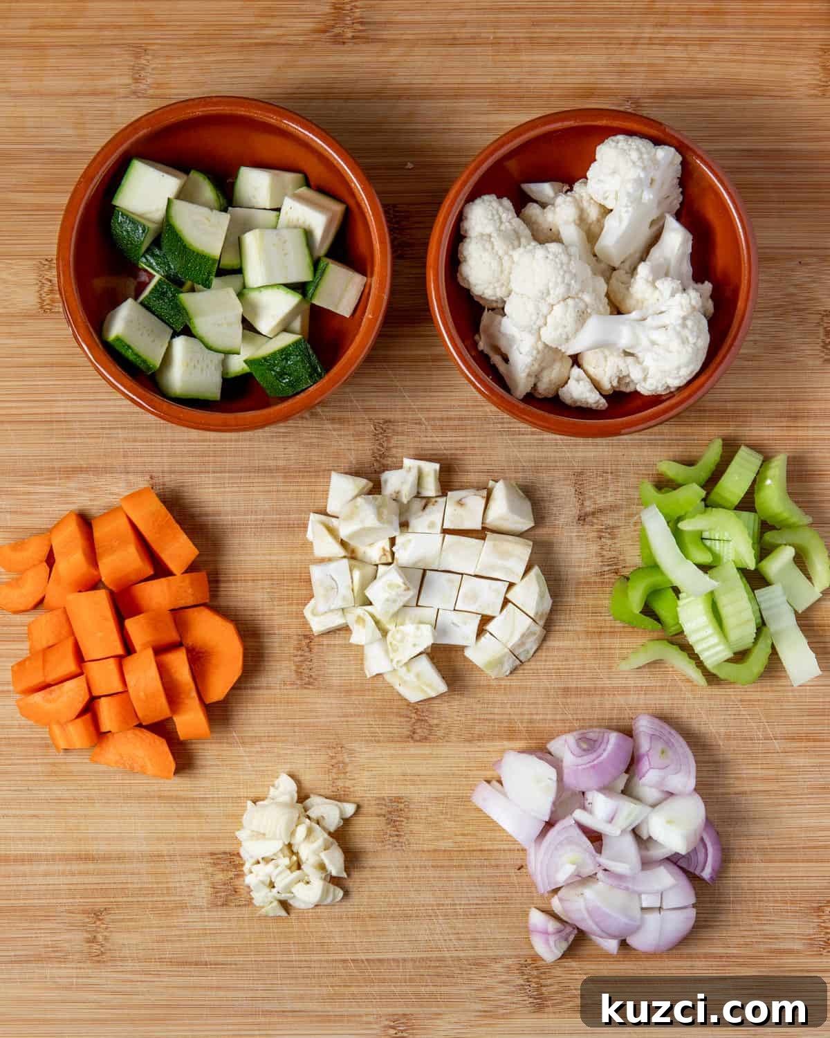 Vegan Stew with Smoked Tofu and Vegetables 5 Photo showing each of the vegetables cut into chunks in little piles on a wooden chopping board.