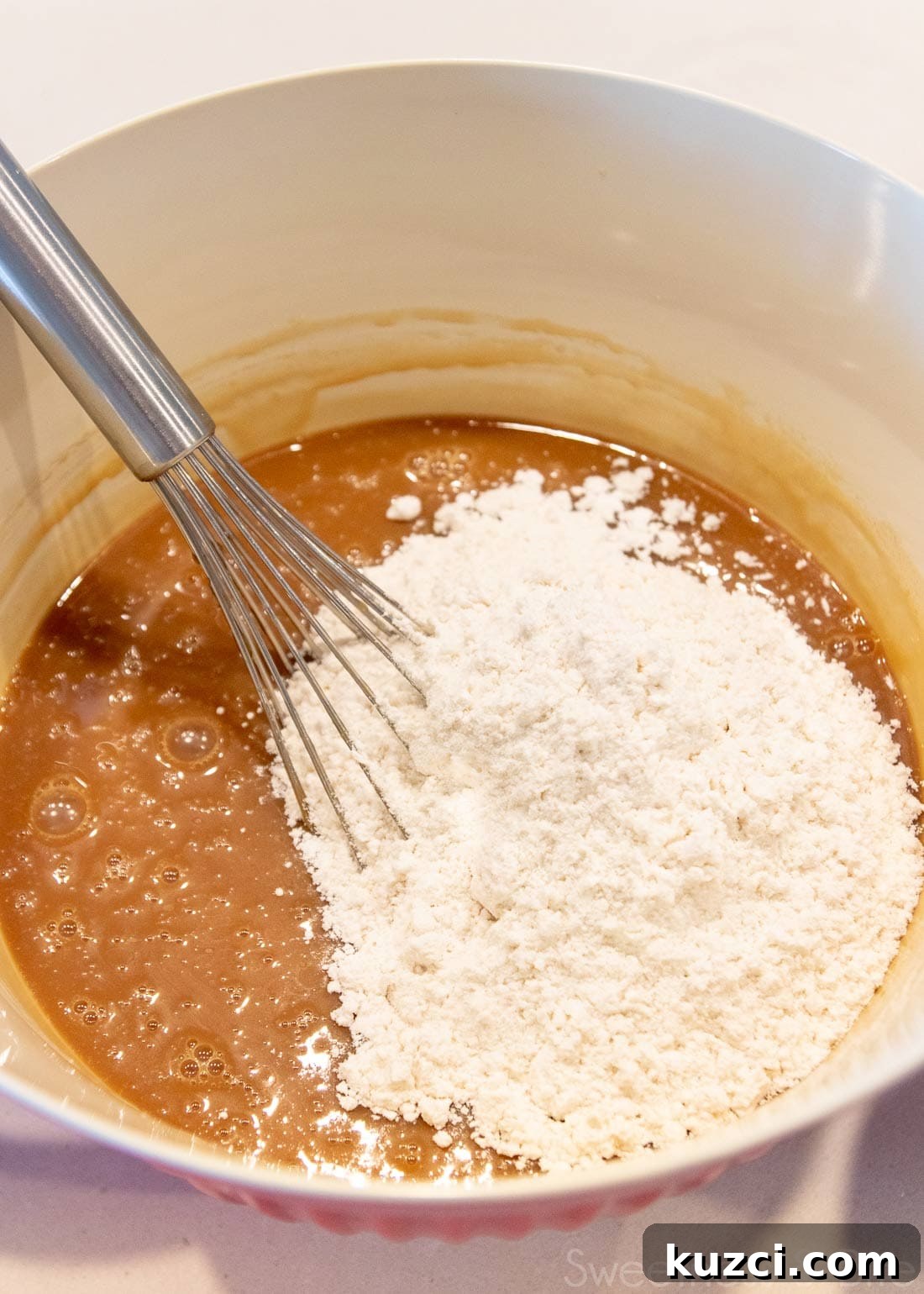 Caramel Mud Cake Recipe with Gluten Free Option 6 Large bowl with caramel mud cake batter and a balloon whisk.