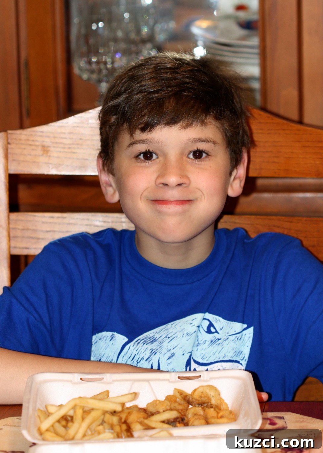 B eat calamari Child eating calamari indoors
