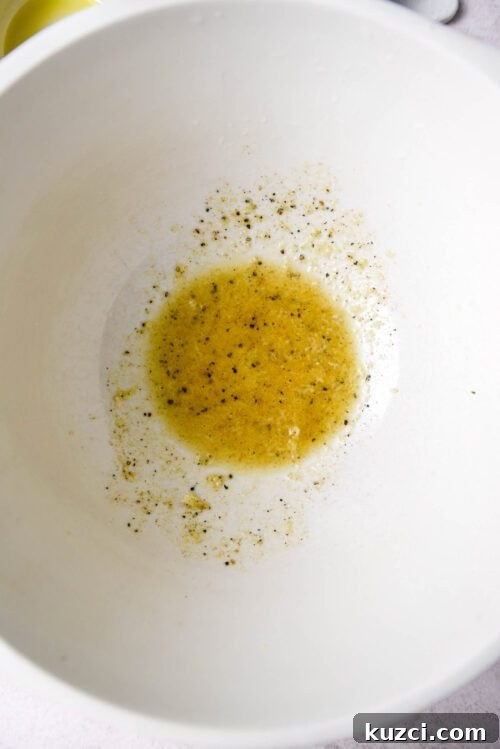 Olive oil vinaigrette in a mixing bowl.