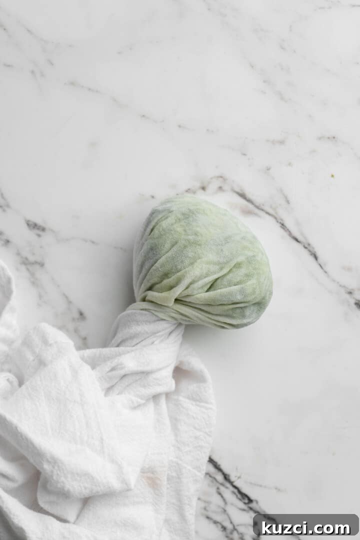 Tzatziki: Greek Yogurt and Cucumber Sauce Recipe 6 Overhead view of grated cucumber wrapped in white kitchen towel