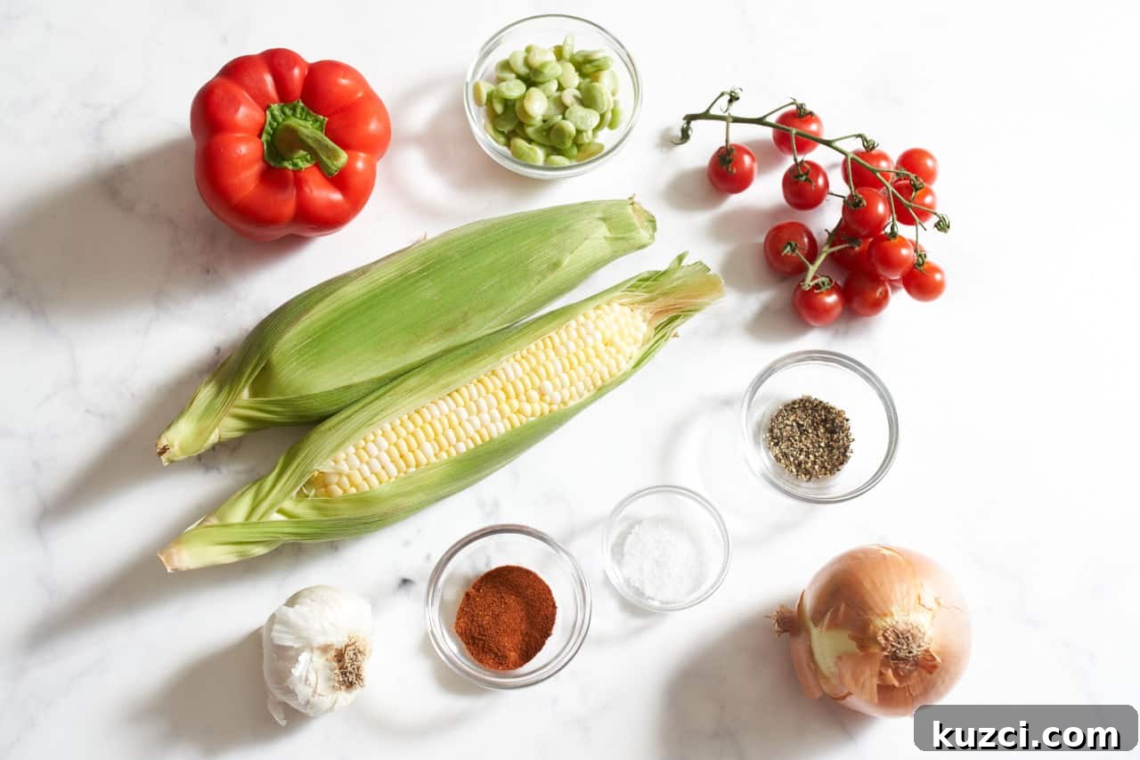 Two ears of corn in husks, an onion, a red bell pepper, some cherry tomatoes on the vine, a garlic bulb, and small bowls of kosher salt, smoked paprika, and black pepper.