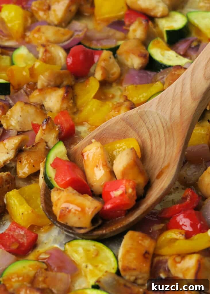 Sheet Pan Chicken and Vegetables: A Kabob Alternative 12 Scooping a serving of Sheet Pan Chicken & Veggies