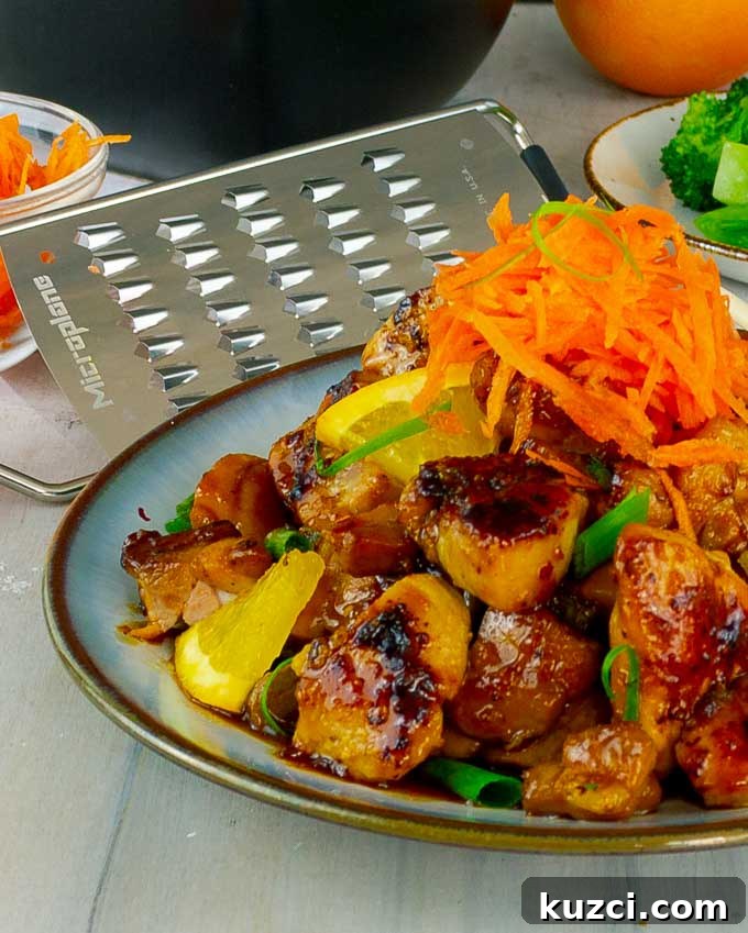 Sticky Orange Chicken Recipe with Tangy Citrus Glaze 2 plate of Sticky Orange Chicken Recipe with a carrot garnish