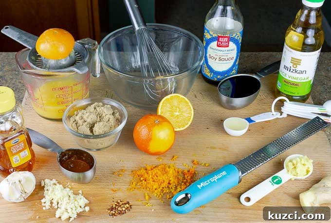 Sticky Orange Chicken Recipe with Tangy Citrus Glaze 4 ingredients for Sticky Orange Chicken Recipe on a cutting board