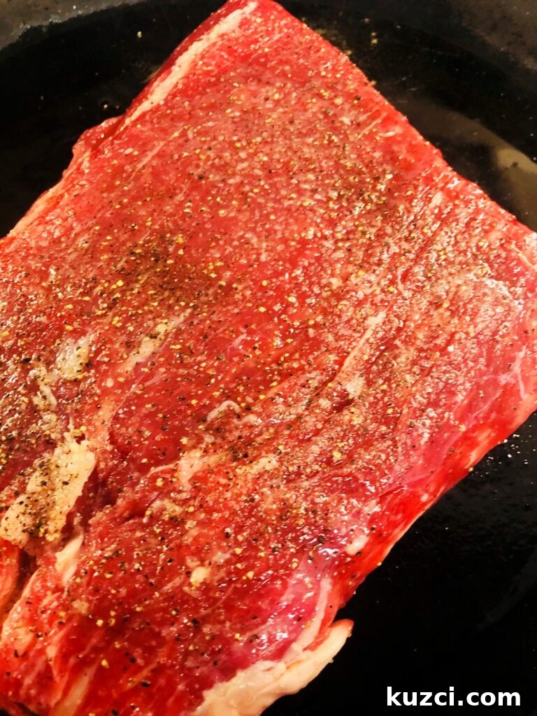 Cajun Garlic Butter Flank Steak Recipe 5 Seasoned steak in skillet before cooking
