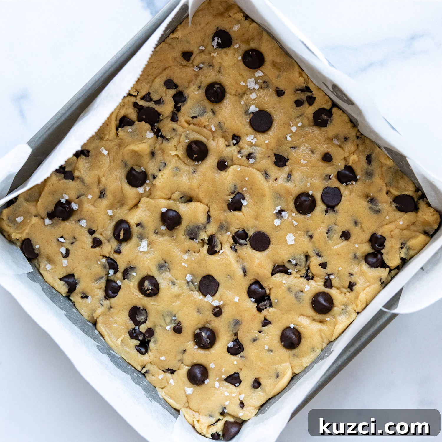 Gluten-free cookie bar dough pressed into a baking pan.