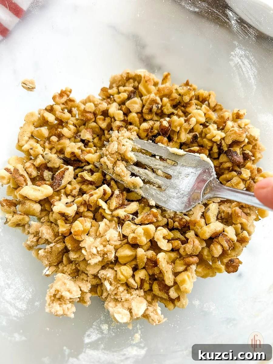 Mixing the topping with a fork in a glass bowl.
