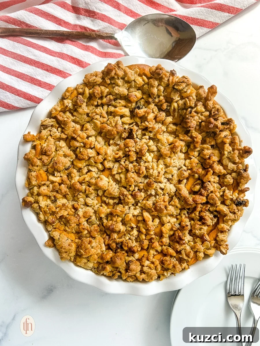 Casserole topped with oats and nuts in a white dish.