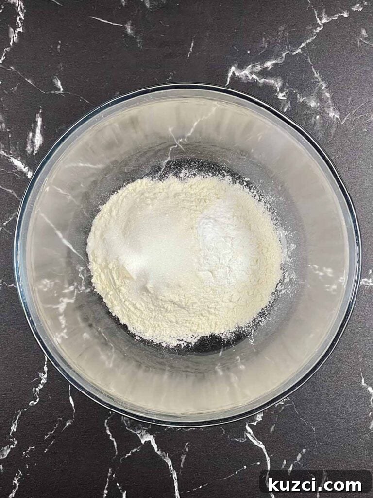 Fluffy Homemade Buttermilk Banana Pancakes 5 Flour, baking powder, baking soda, and kosher salt in a mixing bowl for pancakes.