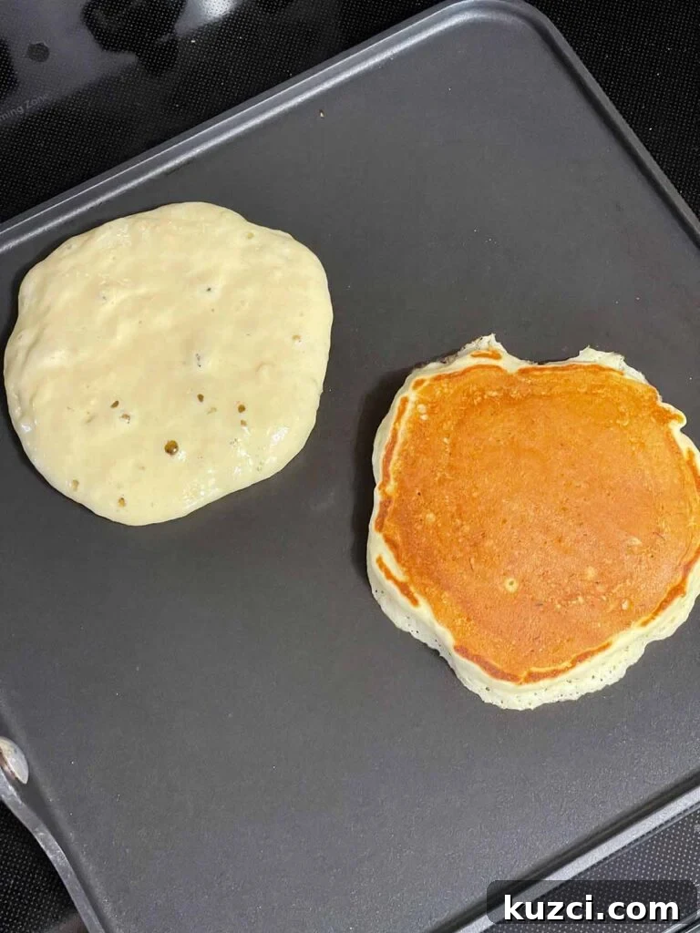 Fluffy Homemade Buttermilk Banana Pancakes 10 Flipping banana pancakes as they turn golden brown on a griddle.