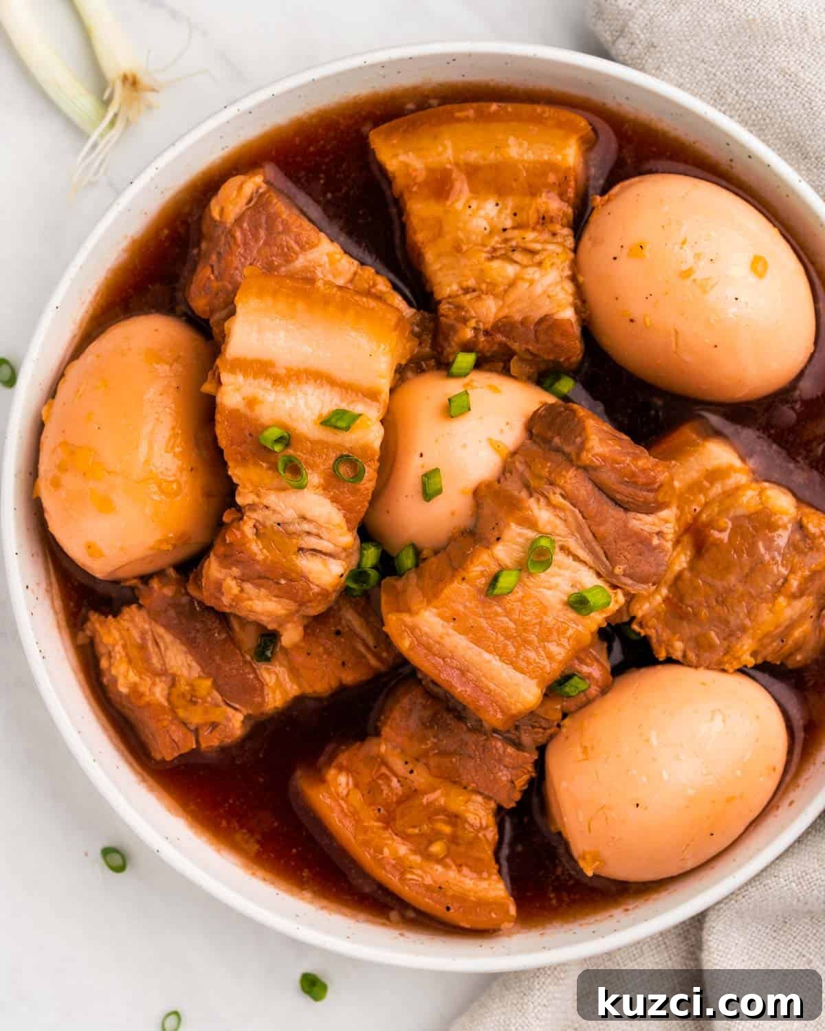 Close up of bowl of thit kho with pork belly and hardboiled eggs.