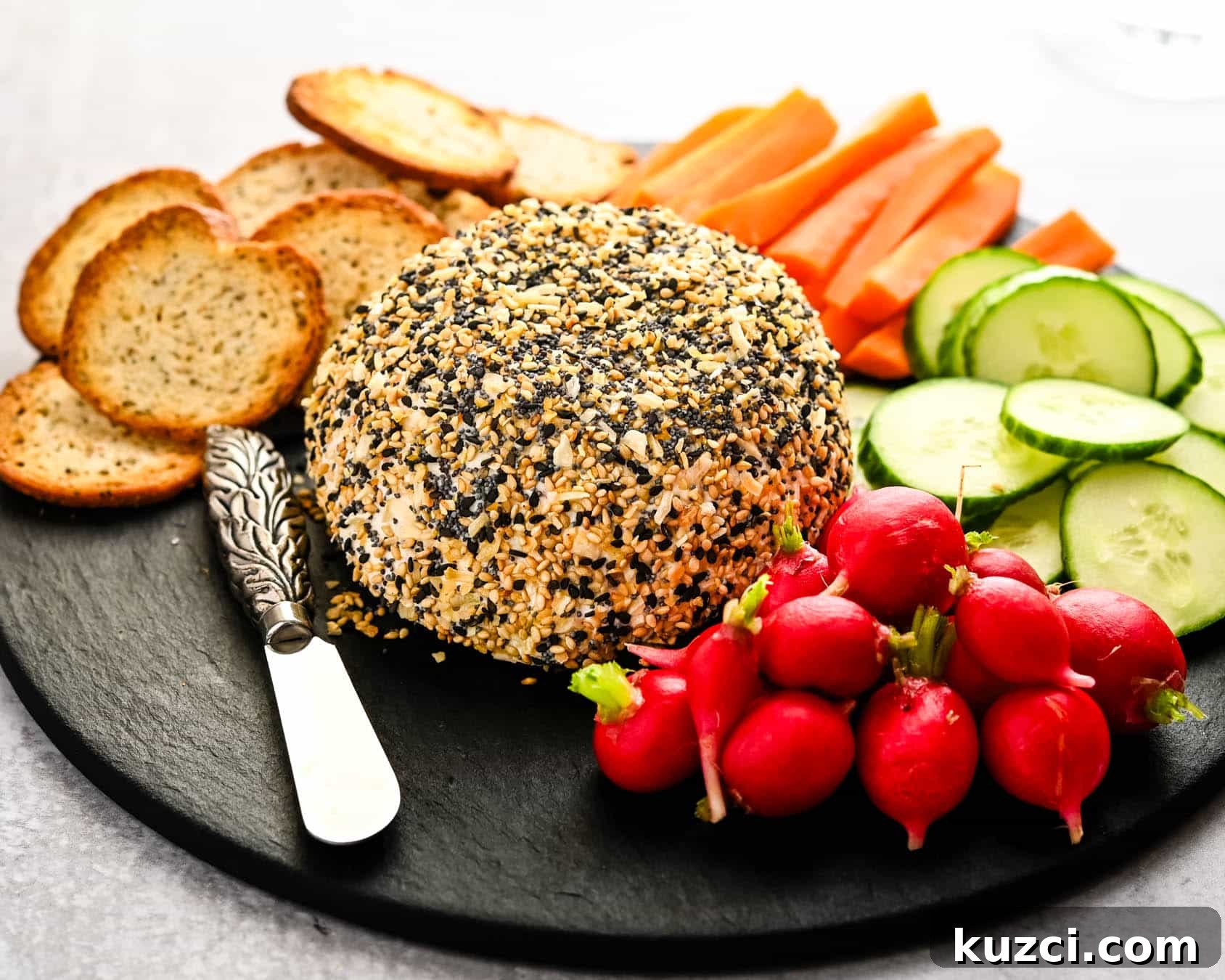 Smoked Salmon Cheese Ball with Dill and Capers 2 Salmon ball on a charcuterie board.