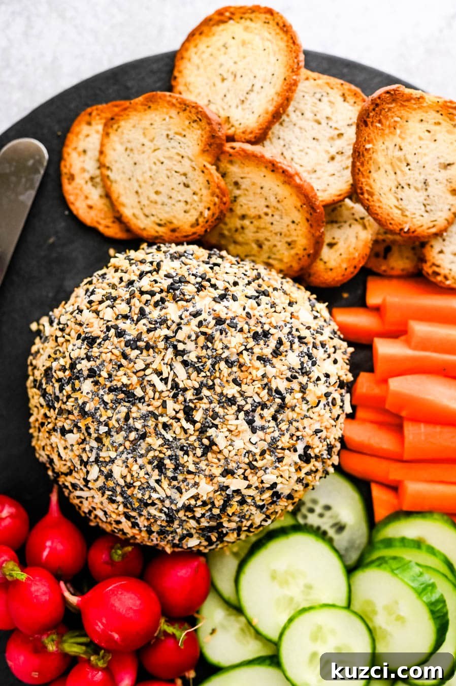 Smoked Salmon Cheese Ball with Dill and Capers 12 A salmon cheese ball with Everything Bagel seasoning on a platter.