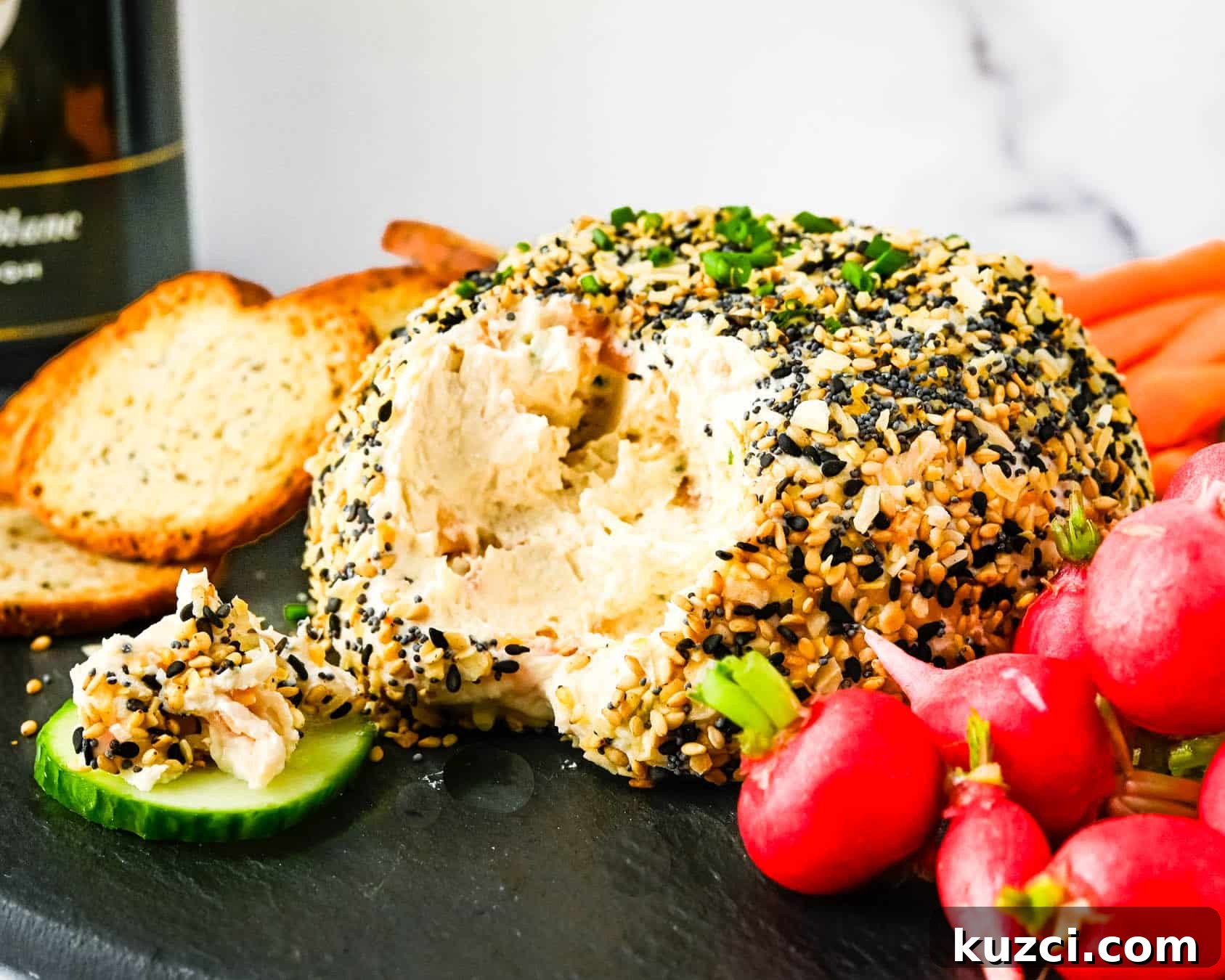 Smoked Salmon Cheese Ball with Dill and Capers 14 Scooping the salmon cheese ball onto crudité.
