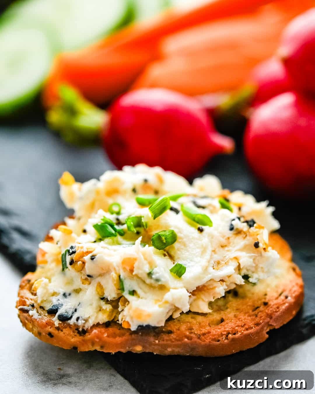 Smoked Salmon Cheese Ball with Dill and Capers 17 Topping a bagel chip with a spread of the goat cheese appetizer.