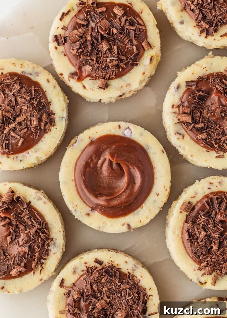 Mini Easter Egg Cheesecakes with Chocolate Ganache Recipe 16 Mini egg cheesecakes with chocolate ganache on a marble platter.