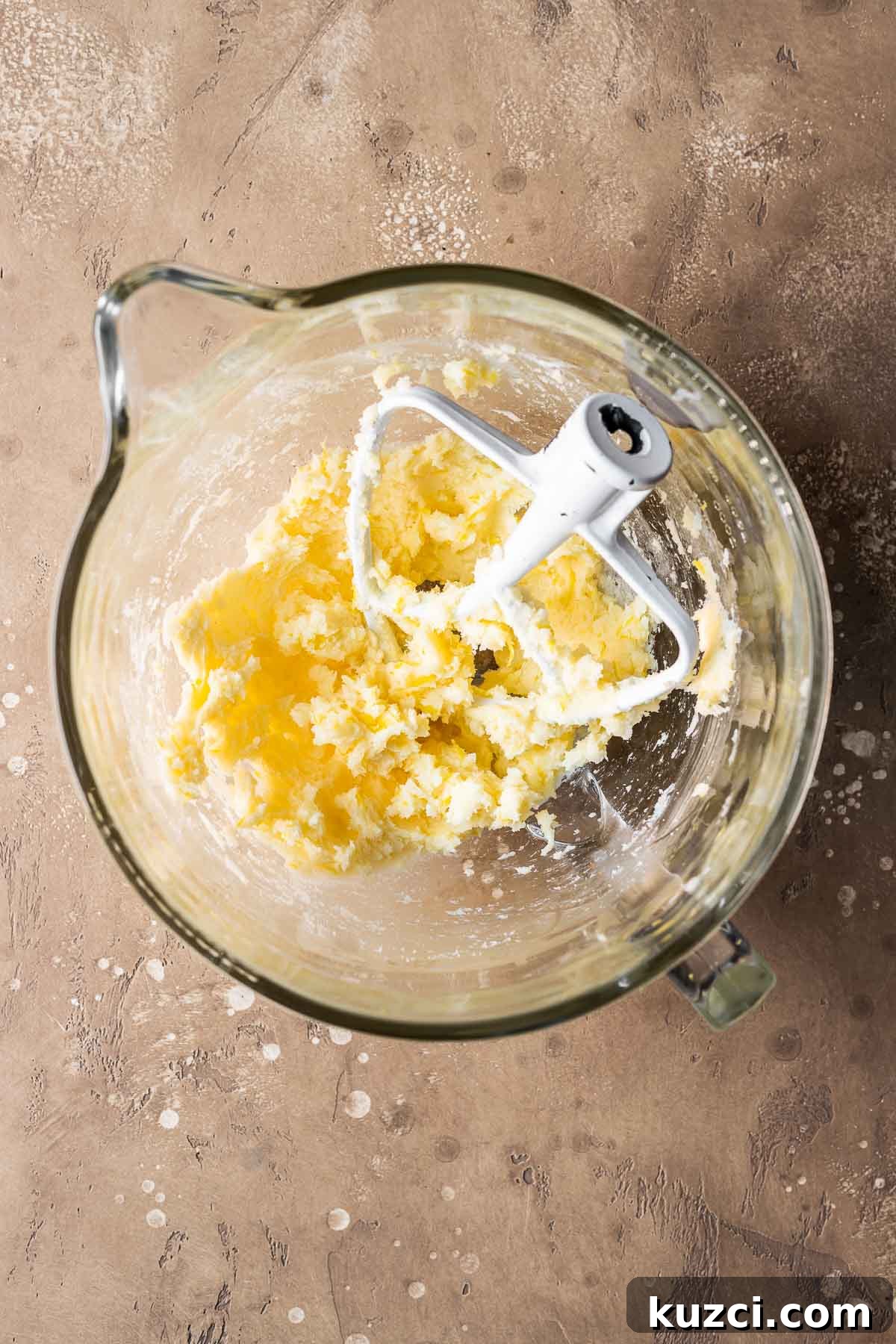 Wet ingredients for pastry dough in a clear glass mixing bowl.