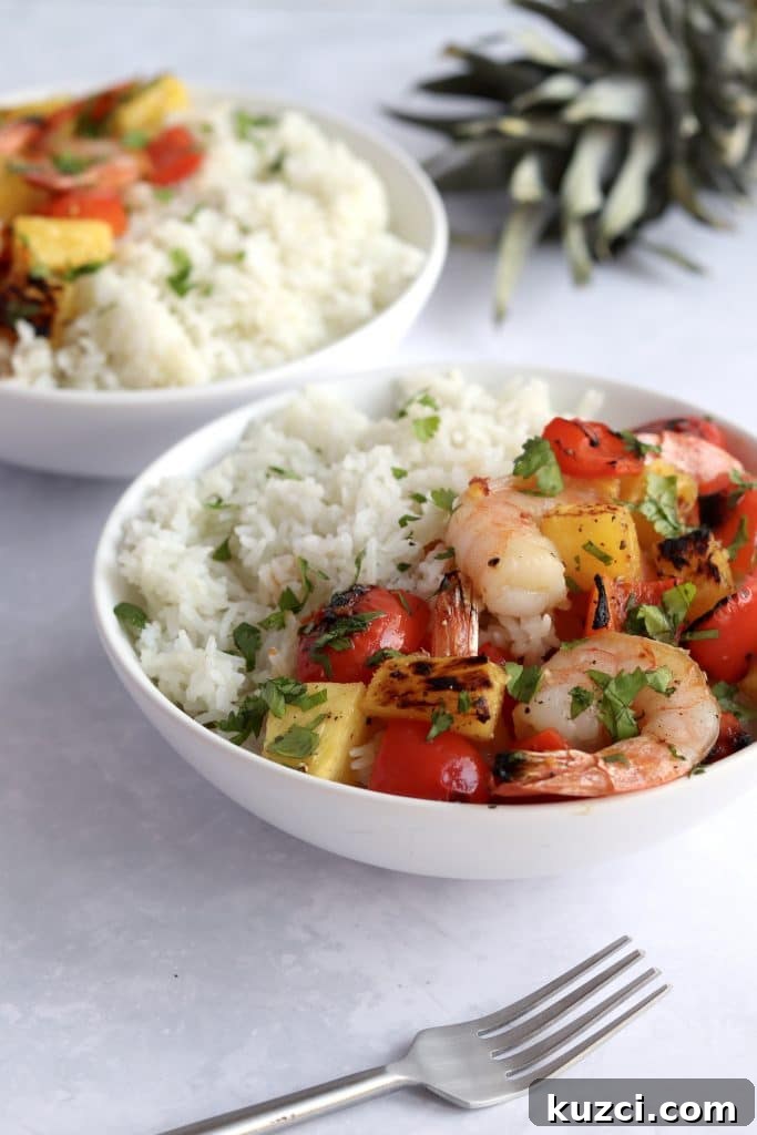 Sheet Pan Shrimp with Pineapple and Garlic Lime Glaze 5 Two bowls of Hawaiian pineapple shrimp with white rice.
