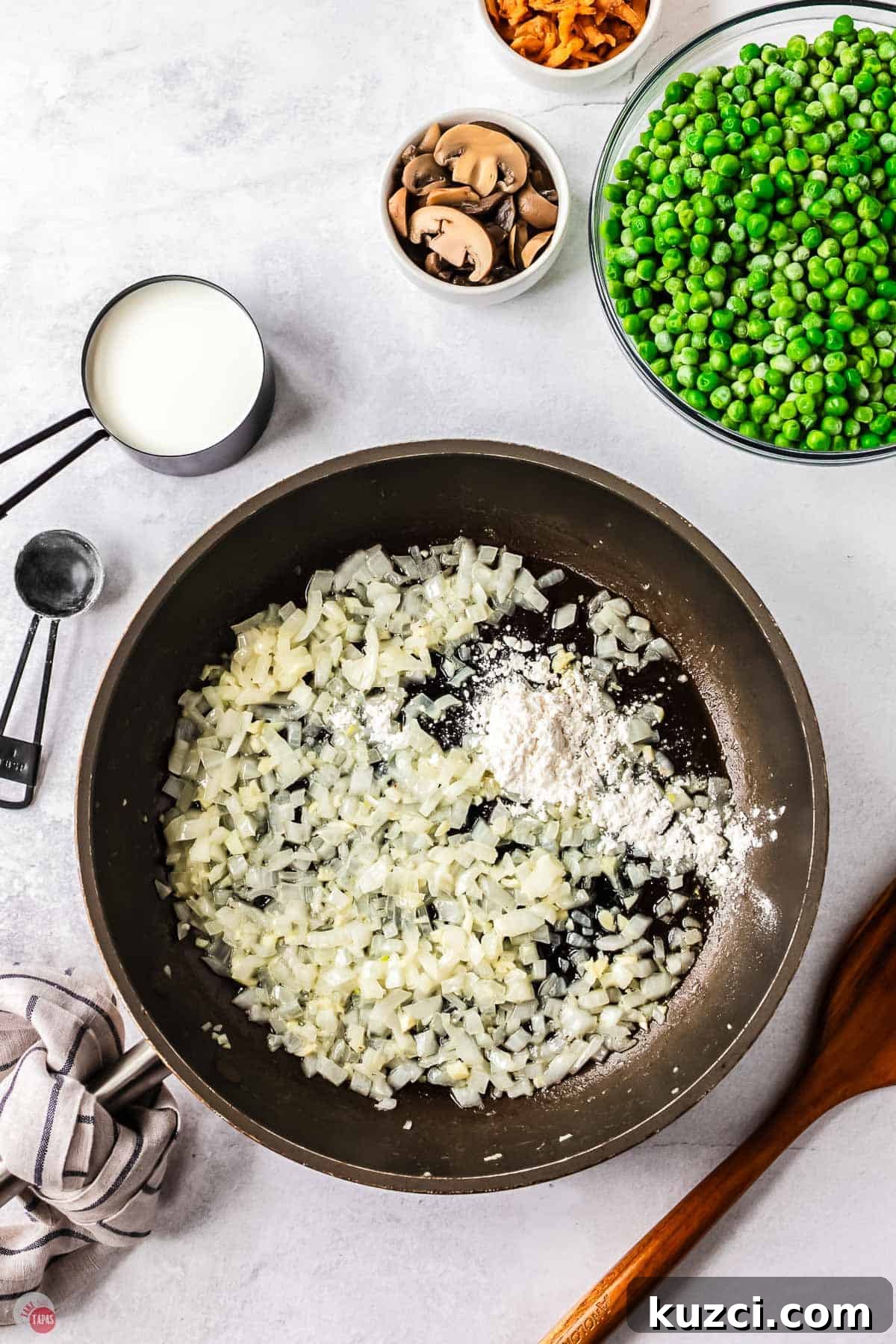 skillet with onion cooking with flour sprinkled on them